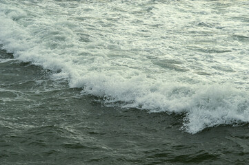 Foam waves crashing on the rocks.