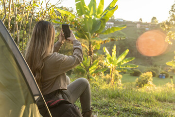 latina woman camping with her cellphone