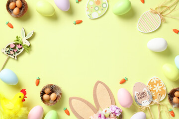 Fototapeta na wymiar Happy Easter concept. Frame of Easter eggs, rabbit, bunny ears, wooden eggs decorations on green background
