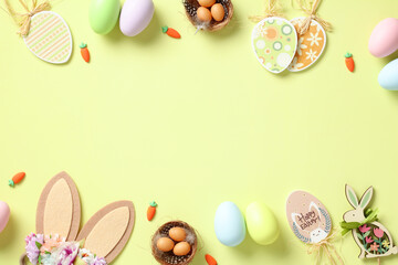 Happy Easter greeting card template. Flat lay composition with Easter eggs, bunny ears, decorations on green background.