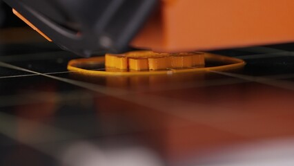 Fototapeta premium The process of printing a part on a 3D printer, close-up. Watch as our printer brings each tiny part to life, printing it layer by layer and accurately recreating a given part model.