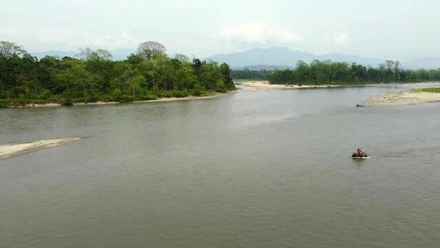 Range forest officer ride elephant in the kameng river  in nameri national park in assam in the eastern himalayan mountains. assam, india