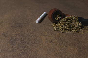 Smoking pipe, a handful of tobacco and a cigarette.