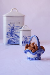 Beautiful background with raw almonds in a porcelain basket

