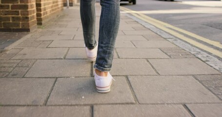 Walking, city and feet of person on sidewalk for travel, explore and adventure in urban town. Ground, street and closeup of shoes on pavement for commute, journey and movement on weekend outdoors