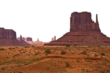 Fototapeta na wymiar The Monument Valley in Utah–Arizona state with the crossing road in the desert - The valley is considered sacred by the Navajo Nation - USA - Cutout concept with no sky for white background copyspace