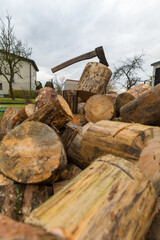 An ax for splitting firewood stuck into a stump for chopping wood.