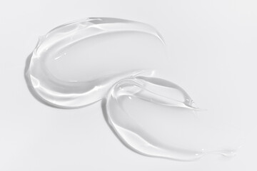 Transparent liquid gel on white background. Cosmetic skincare product texture. Face cream, body lotion swipe swatch