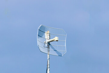 antenna for receiving Internet and Wi-Fi signals on a background of blue sky. satellite tracking