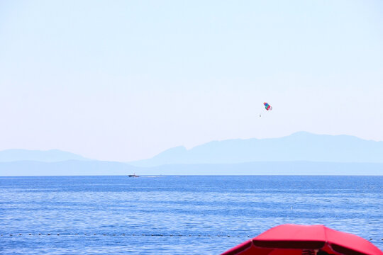 Beautiful seaside landscape and parasailing parachute in Brela, Croatia.