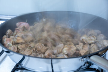 Cooking chicken gizzard livers and hearts using pan