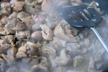 Cooking chicken gizzard livers and hearts using pan