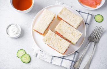 Salmon cucumber dill cream cheese tea sandwich in a plate