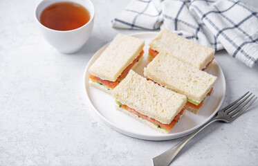 Salmon cucumber dill cream cheese tea sandwich in a plate