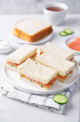 Salmon cucumber dill cream cheese tea sandwich in a plate