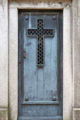  Blue Wooden Door with a Carved Cross in a Mausoleum at Recoleta Cemetery, Buenos Aires, Argentina 