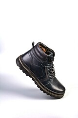 Black winter boots on a white background