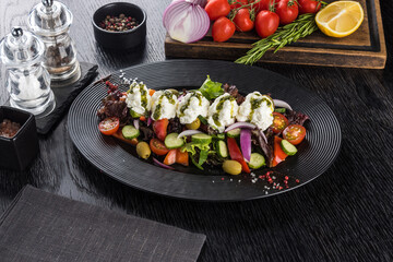 Vegetable salad with feta mousse on a black stone tray