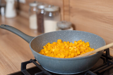 pumpkin fried in a frying pan on the stove