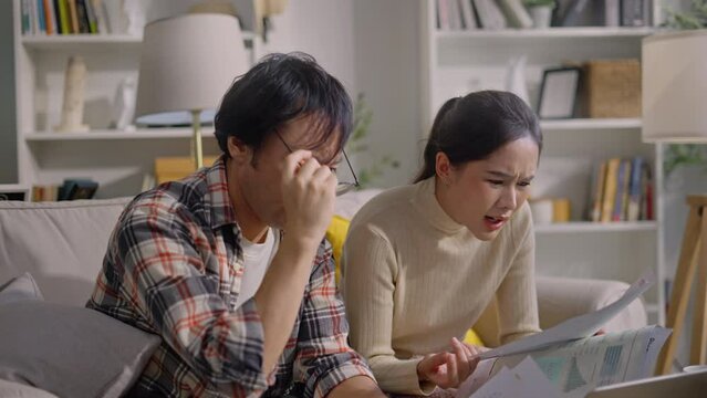 upset millennial couple counting overspent budget,Unhappy young woman feeling stressed calculating monthly expenses at home,lack of money for utility household or rental payments, bankruptcy concept