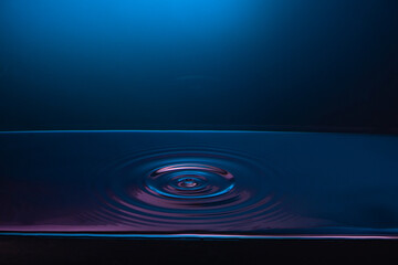 Serene water ripple under moody blue lighting