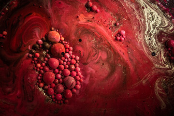 Swirling maroon and crimson hues with floating bubbles and spheres creating an abstract underwater ink pattern.