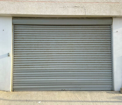 Sturdy metal door designed for industrial garages, provides security and durability