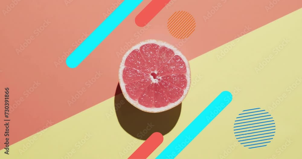 Poster composition of halved grapefruit and abstract shapes on yellow and red background