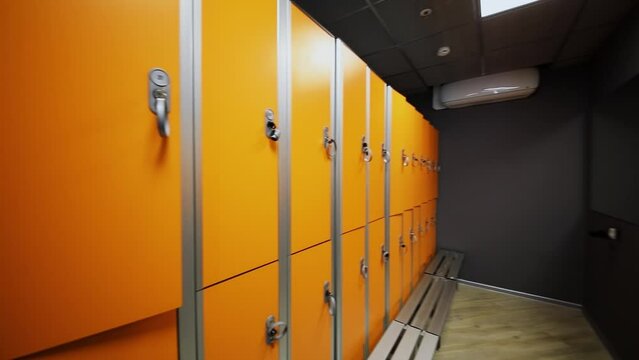 Row of lockers and mirror in dressing room of fitness club