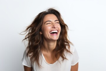 Portrait of laughing young woman in white t-shirt on white background