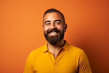 Portrait of a handsome man with beard and mustache on orange background