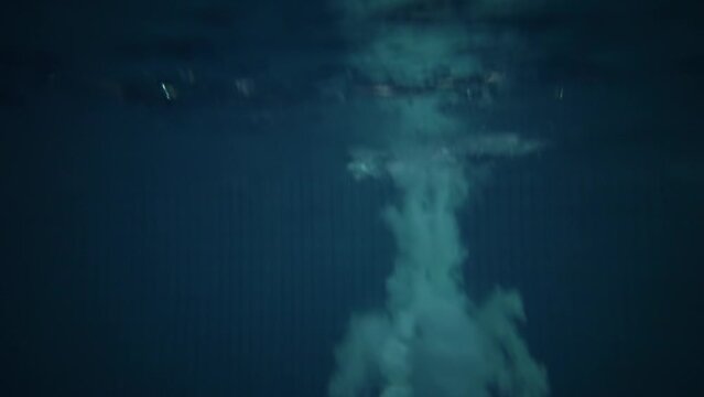  Young man makes back flip during water jump from divingboard in RGUFK basin. Slow motion