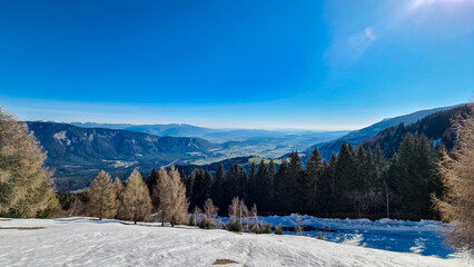 Panoramic view from mountain peak Dreilaendereck in untamed Karawanks, Carinthia, Austria. Alpine landscape in spring in Austrian Alps. Looking at alpine valley, hills and forest. Wanderlust in nature