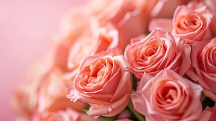 Flower arranging with close-up pink Hybrid tea roses on a pink background, creating an artificial flower bouquet peach fuzz color 2024.