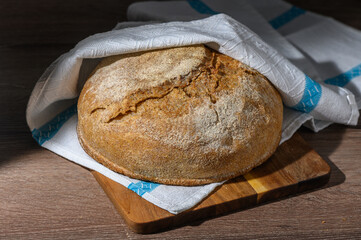 homemade whole grain bread in the kitchen on a wooden table 6