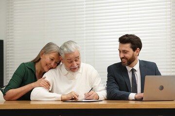 Notary consulting senior couple about Last Will and Testament in office