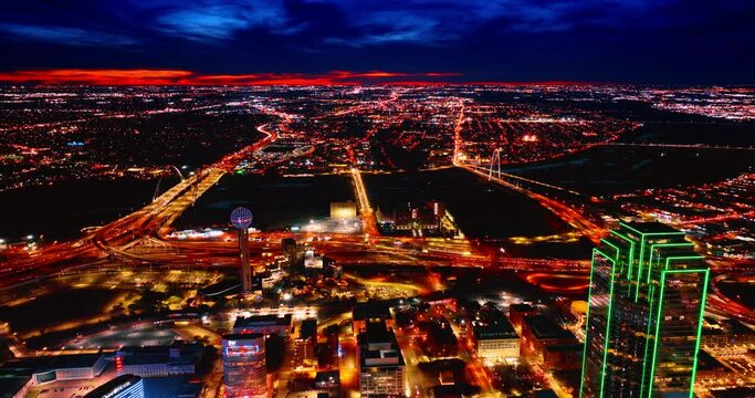 Dallas cityscape with three bridges in the centre. Beautiful view of a night city with multiple lights. Drone footage.