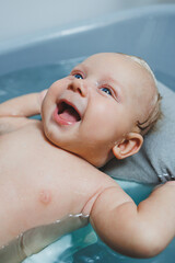 Caring for a newborn baby, bathing the baby. Bathing a baby in a bathtub. Baby's first baths