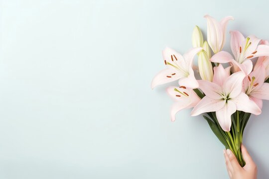 Spring flowers lily. Bouquet of flowers on pastel background. Valentine's Day, Easter, Birthday, Happy Women's Day, Mother's Day. Flat lay, top view, copy space for text