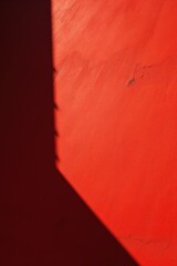 Red wall with shadows on it
