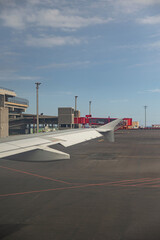 View of airport showing an airplane ready for take-off, airport building, airport facilities