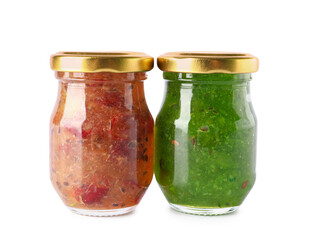 Jars with tasty gooseberry jam on white background