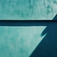 Teal wall with shadows on it