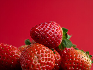 Ripe strawberries on a red background. Strawberries close up.