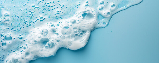 splash of foam from soap or shampoo on blue background