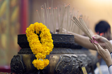 Burning incense sticks and offering garland of flowers