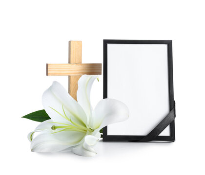 Blank photo frame with lily flower and cross on white background