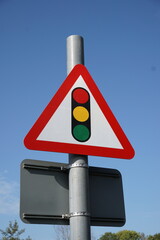 Traffic lights ahead warning sign. Triangular road sign warning motorists of signal lights ahead 