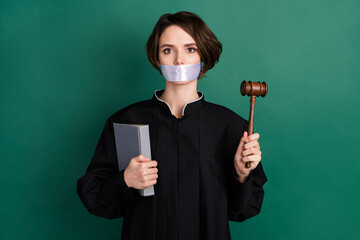 Photo of serious beautiful attractive woman judge attorney close mouth holding gavel isolated on...