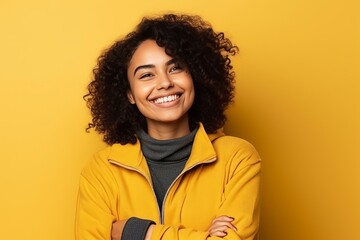 Obraz na płótnie Canvas Portrait of a beautiful young african american woman smiling over yellow background